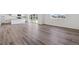 Bright living space featuring light wood floors, seamlessly flowing into the kitchen area at 18971 E 96Th Pl, Commerce City, CO 80022