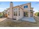 Rear exterior view of a home featuring a patio, bay windows, and a well-maintained lawn at 2299 S Norse Way, Lakewood, CO 80228