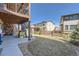 Spacious backyard with lush green grass, patio, and fence, perfect for outdoor enjoyment at 7994 S Kewaunee St, Aurora, CO 80016