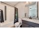 This cozy bathroom features a shower with a decorative shower curtain and a granite countertop at 7994 S Kewaunee St, Aurora, CO 80016