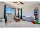 This inviting bedroom features large windows, plush carpet, and a cozy recliner at 7994 S Kewaunee St, Aurora, CO 80016
