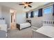 Sunny bedroom with two twin beds, carpet, and ensuite bath provides a comfortable private space at 7994 S Kewaunee St, Aurora, CO 80016