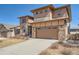 Charming two-story house with a two car garage, stone and wood accents, and a well kept front yard at 7994 S Kewaunee St, Aurora, CO 80016