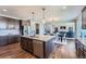 Modern kitchen with stainless steel appliances, a center island, and an open layout into the dining area at 7994 S Kewaunee St, Aurora, CO 80016