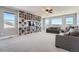 This expansive living room features an entertainment center and large windows offering plenty of light at 7994 S Kewaunee St, Aurora, CO 80016