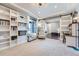 Bright living room with bookshelves and view to a large sliding door to another room in the home at 7994 S Kewaunee St, Aurora, CO 80016