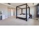 Spacious main bedroom featuring a tray ceiling, four-poster bed, and neutral color palette at 7994 S Kewaunee St, Aurora, CO 80016