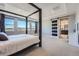 Serene main bedroom with four-poster bed, tray ceiling, and sliding barn door to ensuite bath at 7994 S Kewaunee St, Aurora, CO 80016