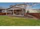 Beautiful backyard featuring covered patio, manicured lawn, and privacy fence, ideal for gatherings at 16400 Alberta Dr, Parker, CO 80134