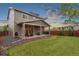 Spacious backyard with a covered patio, lush lawn, and privacy fence, perfect for entertaining at 16400 Alberta Dr, Parker, CO 80134