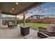 Outdoor patio area with comfortable seating, a fire pit, and well-maintained lawn at 16400 Alberta Dr, Parker, CO 80134