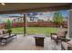 Relaxing backyard patio with a cozy fire pit and beautifully landscaped lawn with string lights for evening ambiance at 16400 Alberta Dr, Parker, CO 80134