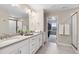 Bright bathroom with double vanity, neutral tones, and a walk-in closet for ample storage at 16400 Alberta Dr, Parker, CO 80134