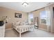 Serene bedroom with neutral tones, plush bedding, and ample natural light from large windows at 16400 Alberta Dr, Parker, CO 80134