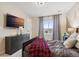 Bedroom featuring a large TV, dresser, and a cozy atmosphere at 16400 Alberta Dr, Parker, CO 80134