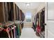 Walk-in closet with ample hanging space, shelving, and a window for natural light at 16400 Alberta Dr, Parker, CO 80134