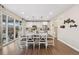 Bright dining room with modern lighting, wood floors, and sliding glass doors that connect indoor and outdoor spaces at 16400 Alberta Dr, Parker, CO 80134