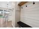 Welcoming entryway with stylish hooks, a built-in bench, and bright, modern finishes leading to the kitchen at 16400 Alberta Dr, Parker, CO 80134