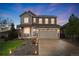 Charming two-story home with a well-manicured lawn, a covered porch, and a two-car garage at 16400 Alberta Dr, Parker, CO 80134