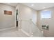 Bright hallway with white banister and neutral walls leads to bedrooms and living areas, showcasing natural light at 16400 Alberta Dr, Parker, CO 80134