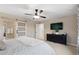 Cozy main bedroom with a sliding barn door, stylish furniture, and a modern entertainment center at 16400 Alberta Dr, Parker, CO 80134