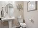 Charming powder room with a pedestal sink, decorative accents, and a clean, modern design at 16400 Alberta Dr, Parker, CO 80134