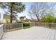 Home showcasing a large wooden deck and a well-maintained lawn at 3205 S Tulare Ct, Denver, CO 80231