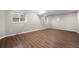 Unfinished basement with wood flooring and natural light from the window at 3205 S Tulare Ct, Denver, CO 80231