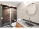 Bathroom features a shower, toilet and sink with modern finishes at 3205 S Tulare Ct, Denver, CO 80231