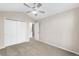 Neutral bedroom features a ceiling fan, carpet and closet space at 3205 S Tulare Ct, Denver, CO 80231
