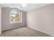 Bright bedroom with a large arched window, offering a view and bringing in natural light at 3205 S Tulare Ct, Denver, CO 80231
