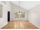 Airy dining room with hardwood floors, natural lighting and a contemporary chandelier at 3205 S Tulare Ct, Denver, CO 80231