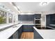 Stylish kitchen with a center island, stainless steel appliances, and bright natural lighting at 3205 S Tulare Ct, Denver, CO 80231