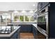 Modern kitchen features new appliances, sleek countertops and hardwood flooring at 3205 S Tulare Ct, Denver, CO 80231