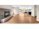Bright living room with hardwood floors, fireplace, and open layout to the modern kitchen at 3205 S Tulare Ct, Denver, CO 80231