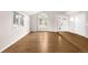 Bright open living room with hardwood floors, front door and a wall of windows at 3205 S Tulare Ct, Denver, CO 80231