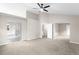 A spacious main bedroom with vaulted ceilings, carpet, and an adjoining bathroom at 3205 S Tulare Ct, Denver, CO 80231