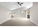 Spacious main bedroom with vaulted ceilings, fan, and multiple windows for ample natural light at 3205 S Tulare Ct, Denver, CO 80231