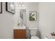Cozy half bathroom featuring a wood vanity, framed art, and a modern toilet at 670 Winona Ct # 38, Denver, CO 80204