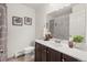 Bathroom featuring a vanity, toilet, framed art, and shower with a marble surround at 670 Winona Ct # 38, Denver, CO 80204