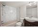 Bathroom featuring a vanity, toilet, and tub with white tile surround at 670 Winona Ct # 38, Denver, CO 80204