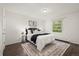 Bright bedroom showcasing a queen bed with an area rug and a window view at 670 Winona Ct # 38, Denver, CO 80204