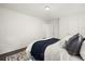 Bright bedroom featuring a queen bed with hardwood floors, and white walls at 670 Winona Ct # 38, Denver, CO 80204