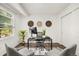 Bright home office with a desk, computer, decorative wall art, and large window at 670 Winona Ct # 38, Denver, CO 80204