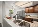 Well-lit kitchen with stainless steel appliances, granite countertops, and dining table by the window at 670 Winona Ct # 38, Denver, CO 80204