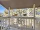 View of a balcony area showing its white railing and with hanging plants, plus an open view to trees and a light blue sky at 4400 S Quebec St # M-204, Denver, CO 80237