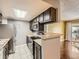Kitchen with stainless steel appliances, breakfast bar, and view of the living room at 4400 S Quebec St # M-204, Denver, CO 80237
