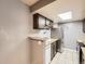 Galley kitchen with tile floor, stainless steel refrigerator, and dark cabinets at 4400 S Quebec St # M-204, Denver, CO 80237