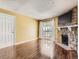 Living room with hardwood floors, fireplace, and sliding glass door to balcony at 4400 S Quebec St # M-204, Denver, CO 80237