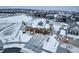 Stunning home with a three-car garage and a snow-covered roof in a beautiful community at 1060 Arrowhead Ct, Erie, CO 80516